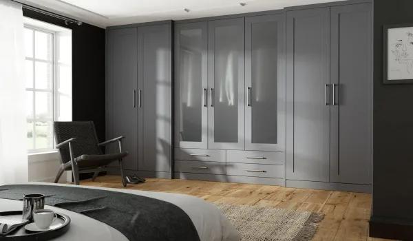 Grey fitted wardrobe along wall, Complete Fitted Furniture.